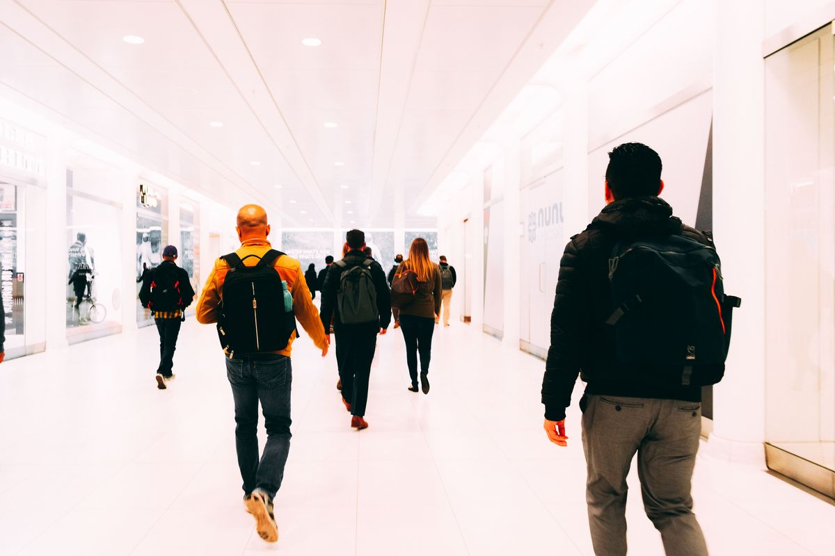 Teacher with a suitcase at an airport departure gate