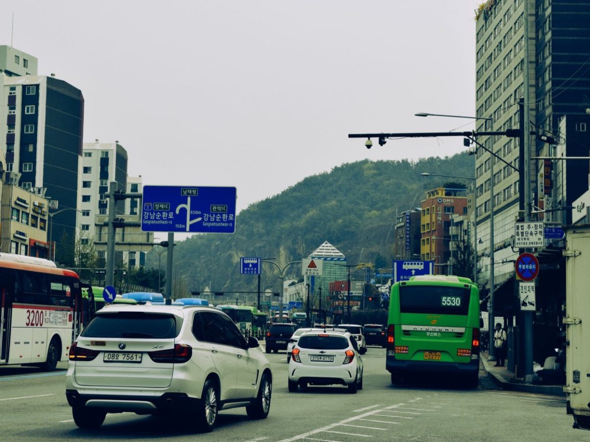 Seoul street with Korean road signs and city buses